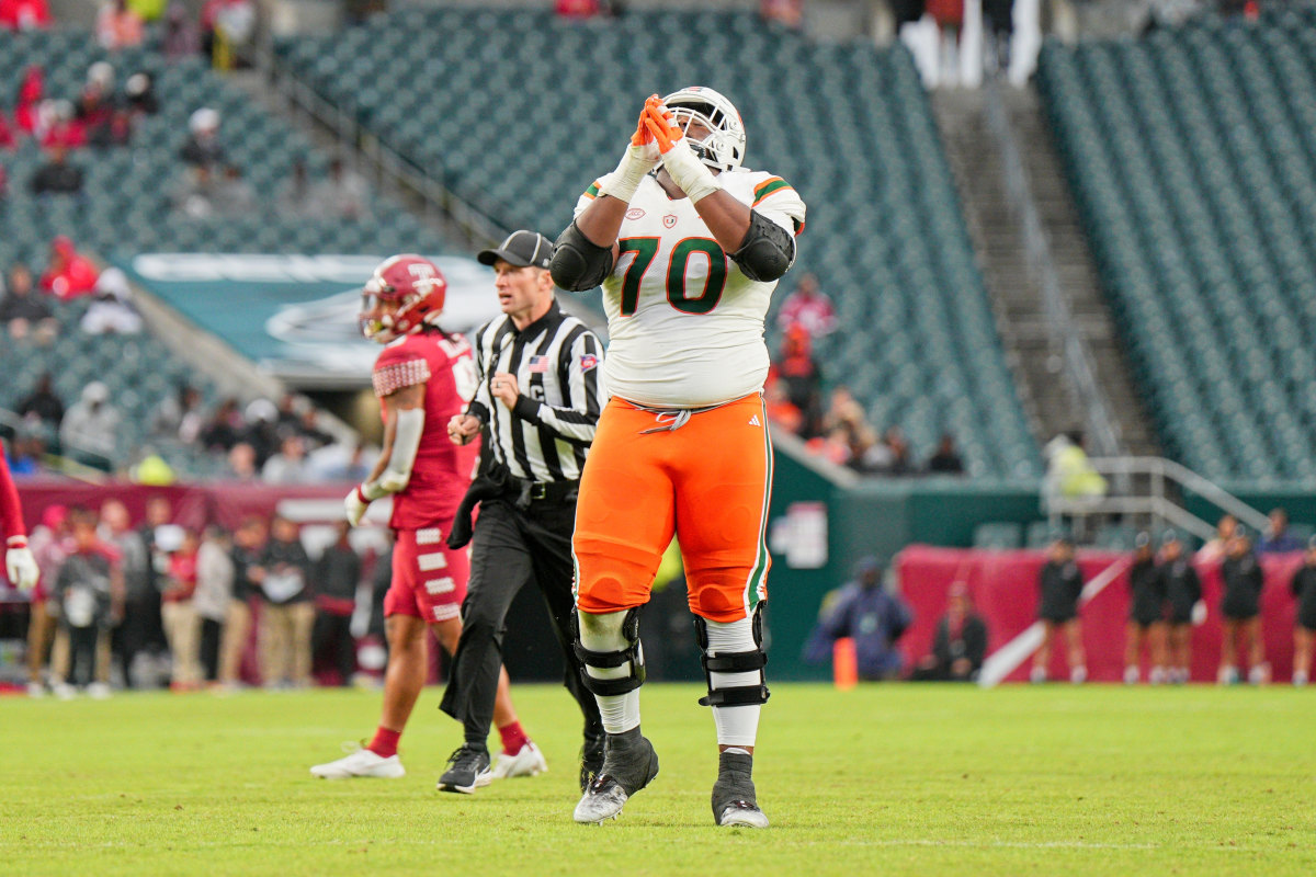 Miami Hurricanes offensive lineman Javion Cohen (70) celebrates a touchdown.